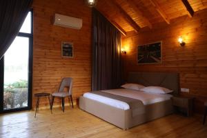 a bedroom with a bed and a chair in it at Kriva Resort in Elbasan +78 photos