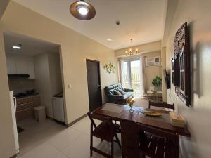 a kitchen and living room with a table and chairs at The Verdin at Maple Grove in Cavite