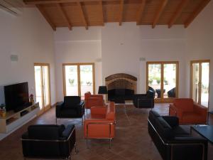 a living room with couches and chairs and a fireplace at Herdade dos Montes Bastos in Santa Luzia