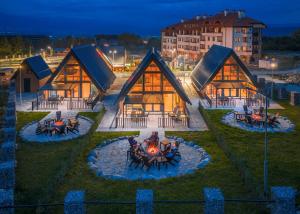 a house with a fire pit in front of it at Camping Bansko "Between the Mountains" in Bansko