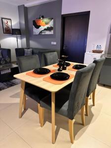 a wooden table with chairs and a dining room at Staye in Islamabad +6 photos