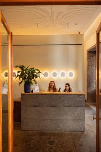 two women sitting at a counter in a bathroom at NINE DOTS Azorean Art Boutique Hotel in Ponta Delgada +83 photos