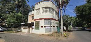a building on the side of a street at Thaayar Homestay by Highpoint in Tiruchirappalli