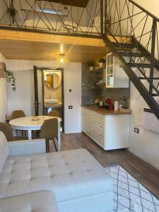 a kitchen and a living room with a table and a couch at Kopel Haus - Studio - Self acces cod location in Baloteşti