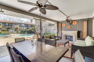 a living room with a wooden table and a fireplace at Pleasanton Gem in Quiet Community w/ Pool Access in Pleasanton