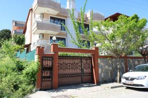 a house with a gate and a white car parked in front at Asfar Villa in Yalova