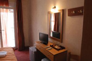 a hotel room with a desk with a television on it at Ducata Hotel - Xirolivado in Xirolívadon +32 photos