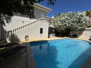 a swimming pool in front of a house at Beach House Lagos - Beachhouselagos - Meia Praia in Lagos