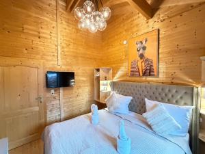 a bedroom with a bed with a zebra picture on the wall at Sky-View Chalet am Waldsee in Rieden
