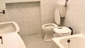 a white bathroom with a toilet and a sink at RM05 - Senigallia, trilocale fronte mare in Senigallia