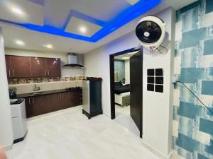 a kitchen with a blue ceiling with a fan at Bahria 777 Luxury Apartment in Lahore