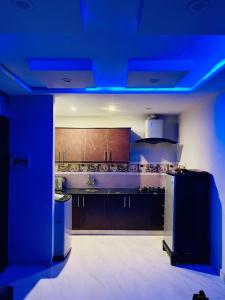 a kitchen with a blue lighting in a room at Bahria 777 Luxury Apartment in Lahore