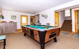 a pool table in the middle of a room at Sunny Delight - KDH MP 7, Ocean View, 130 Yds to Beach, Pool, Hot Tub, Pets OK, Flex Stays in Kill Devil Hills
