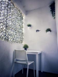 a white chair sitting next to a white desk at Cozy Room G10 in Valencia