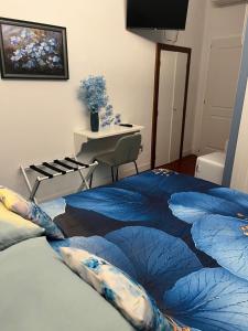 a bedroom with a blue blanket on a bed at Agapanthus in Offida