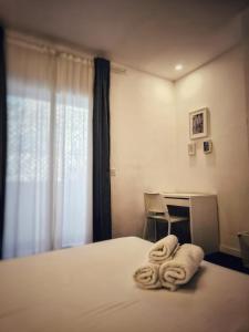 a bedroom with a bed with towels on it at Cozy Room G10 in Valencia +8 photos