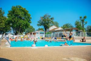 a group of people in a swimming pool at Camping Parc Bellevue - Maeva in Cannes