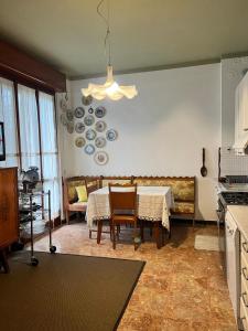 a kitchen with a table and a dining room at Da Carmela Italian Home in Mantova