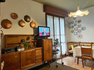 a living room with a tv on a wooden entertainment center at Da Carmela Italian Home in Mantova