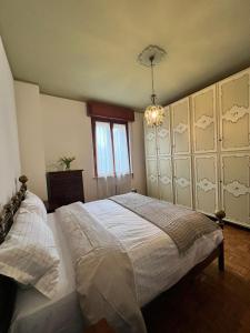 a bedroom with a large bed and a chandelier at Da Carmela Italian Home in Mantova