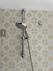 a shower head in a bathroom with a tiled wall at Da Carmela Italian Home in Mantova +44 photos