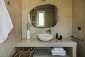 a bathroom with a sink and a mirror at Lourdas White Villa in Kefallonia
