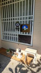 a porch with a table and a bench in front of a window at 包棟Linsen Secret Realm 27 in Tainan