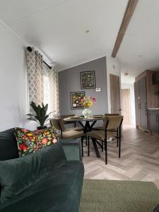 a living room with a couch and a table at B&B Voor De Zee in Westerland +20 photos