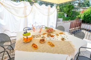 a white table with food on top of it at Villa Bugatti Indipendent Villa ,lake view and private pool, DesenzanoLoft Official Partner Homes & Villas by Marriott Bonvoy in Desenzano del Garda