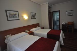 Ein Bett oder Betten in einem Zimmer der Unterkunft Pension Alameda