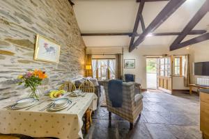 a living room with a table and a stone wall at 2 Bed in Builth Wells oc-39471 in Builth Wells