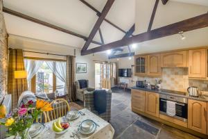 a kitchen and living room with wooden cabinets and a table at 2 Bed in Builth Wells oc-39471 in Builth Wells