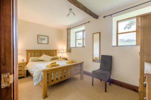 a bedroom with a bed and a desk and a chair at 2 Bed in Builth Wells oc-39471 in Builth Wells