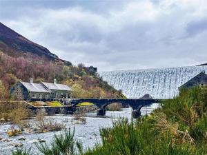a bridge over a river with a waterfall in the background at 2 Bed in Builth Wells oc-39471 in Builth Wells