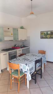 a kitchen with a table with two chairs and a kitchen with a stove at Biogarden in Zelarino