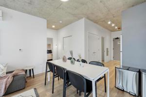 a dining room with a white table and chairs at Envitae Hotel 4BR Modern Sleek Apartment in Chicago +46 photos