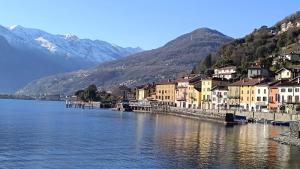 a town next to a body of water with mountains at Oasi di pace in Domaso