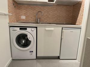 a kitchen with a washing machine and a sink at Oasi di pace in Domaso