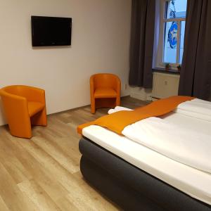 ein Schlafzimmer mit einem Bett und einem TV an der Wand in der Unterkunft Ferienwohnung 1 Christiansdorf Freiberg in Freiberg