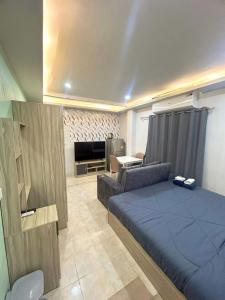 a living room with a bed and a couch at Fora Boutique Hotel in Karon Beach