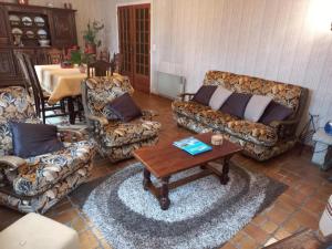 a living room with couches and a table at Charming Breton house in Hénansal in Hénansal