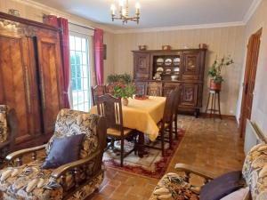 a dining room with a table and chairs at Charming Breton house in Hénansal in Hénansal