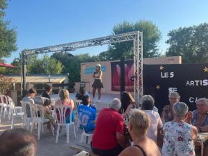 a crowd of people watching a woman on a stage at Camping Parc Bellevue - Maeva in Cannes +34 photos