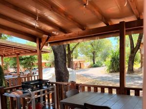 a wooden deck with a table and a tree at Camping Parc Bellevue - Maeva in Cannes