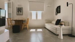 a living room with a couch and a table at AELIA Tinos in Tinos