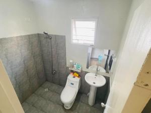 a bathroom with a toilet and a sink and a shower at CasaMia in San Pablo +12 photos