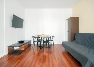 a living room with a table and chairs and a couch at Rooms Green Rydygiera 17 own private room tv wifi in Warsaw