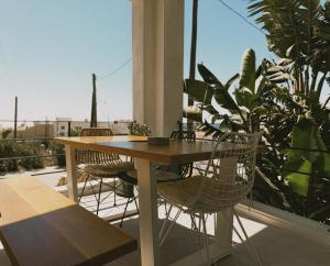 a wooden table and chairs on a balcony at AELIA Tinos in Tinos