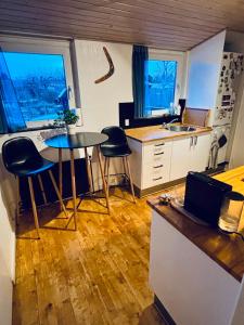 a kitchen with a table and two stools in it at PRIVATE B&B - EASY ACCESS - 24h SELF CHECK IN-OUT in Odense +10 photos