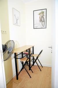 a table and chairs in a room with a bike on the wall at Amor Lisboa Hostel in Lisbon +49 photos